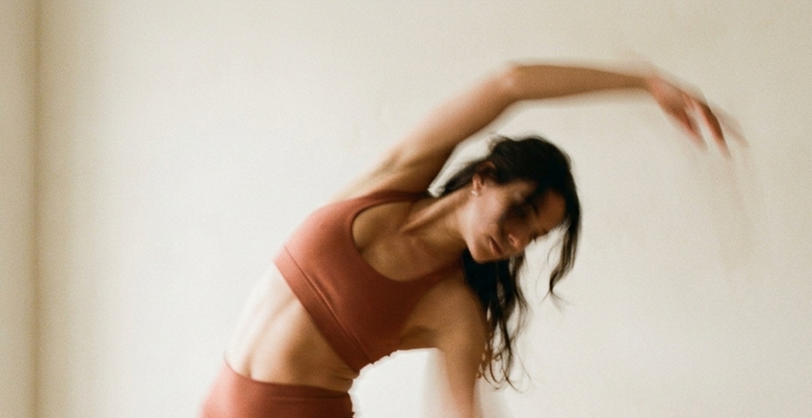 A person stretching in a bright, calm space